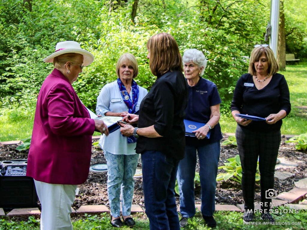 Mary Sterling is presented with a certificate and a pin